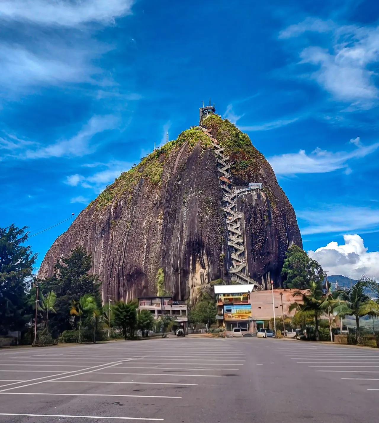 View of El Peñol in Guatapé, Colombia under a bright blue sky